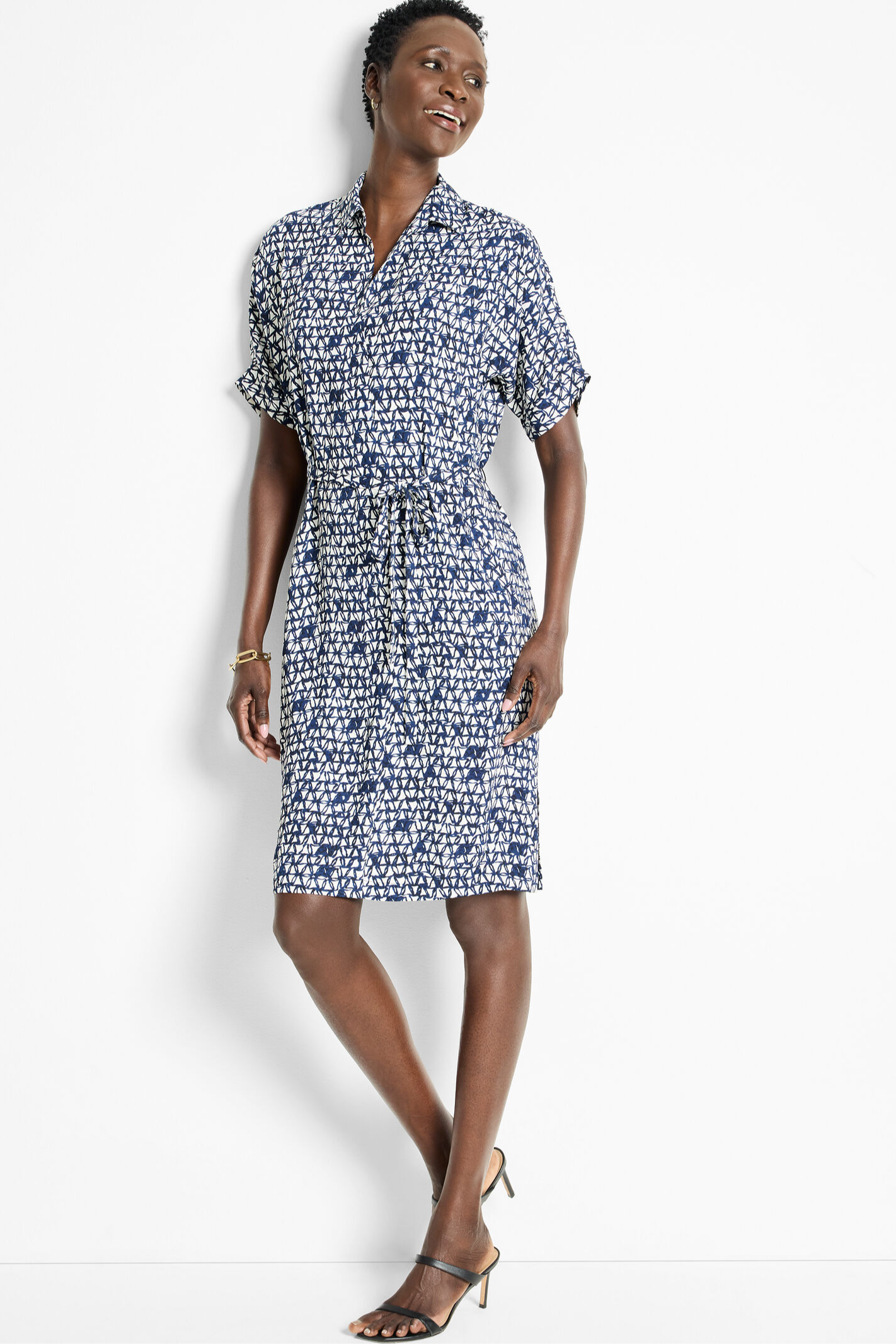 Woman wearing a patterned dress on a white background