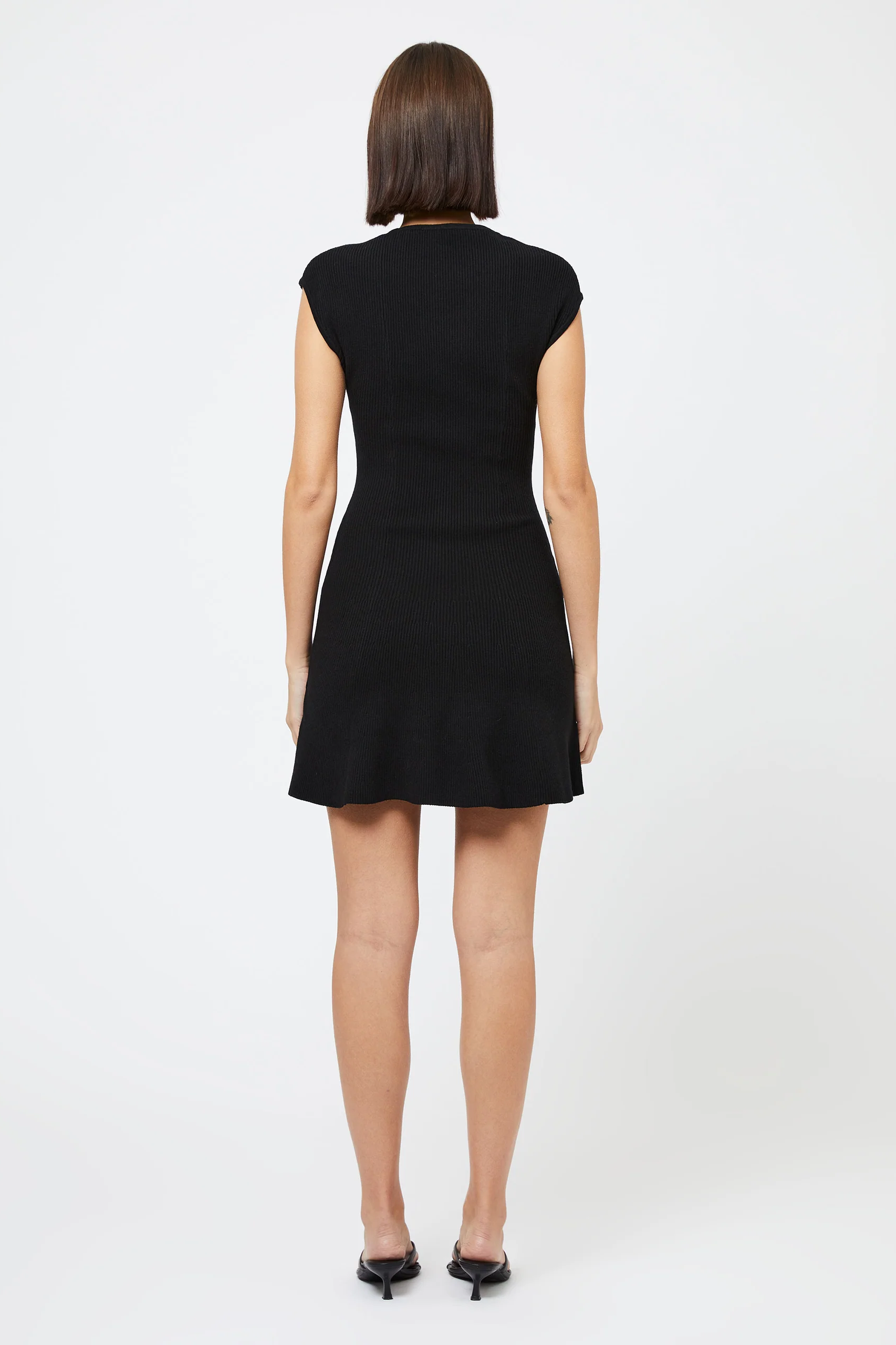 Person wearing a black dress on a white background