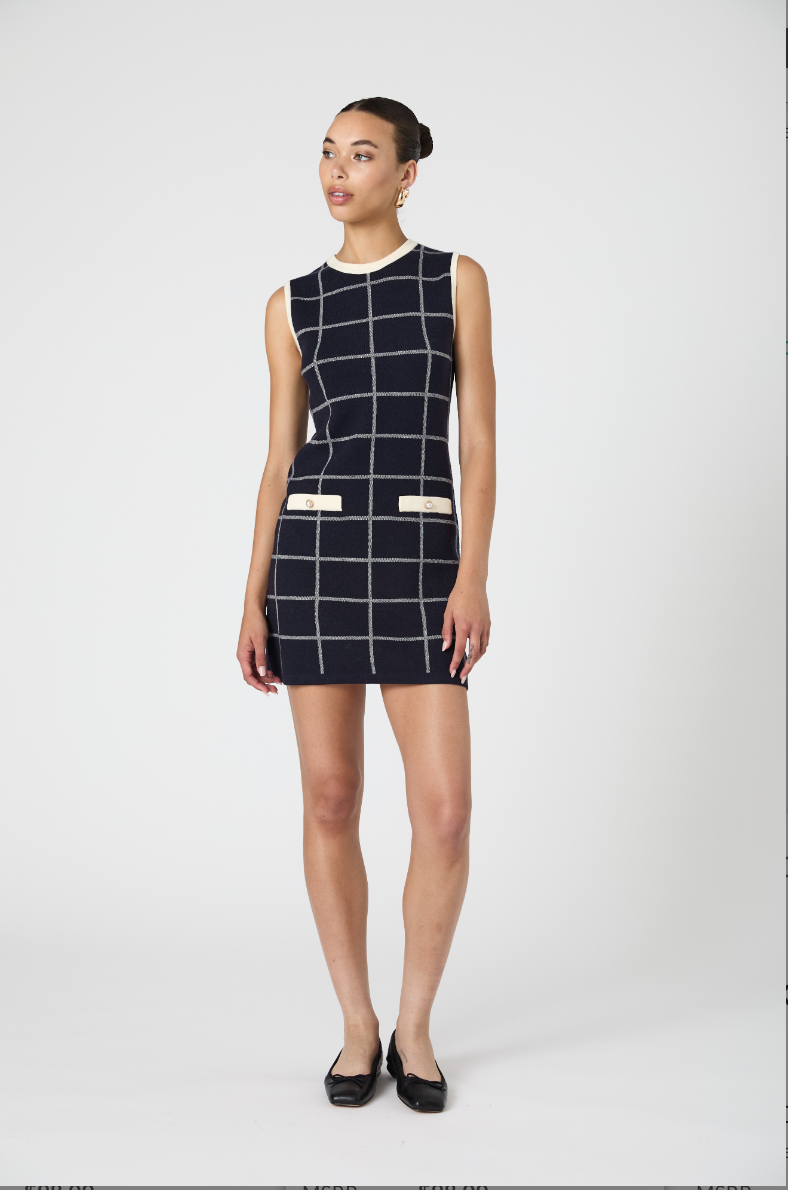 Woman wearing a black and white checkered dress on a white background