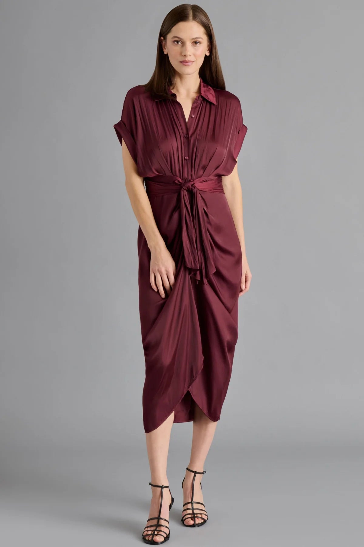 Woman wearing a burgundy dress on a gray background
