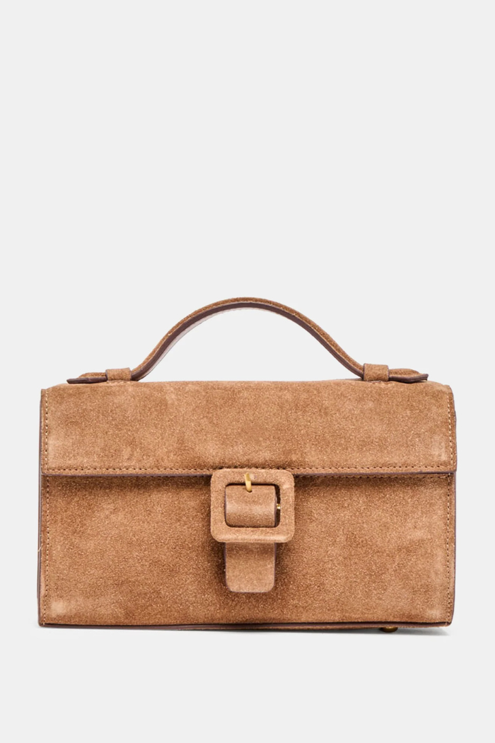 Brown suede handbag with a buckle on a light gray background