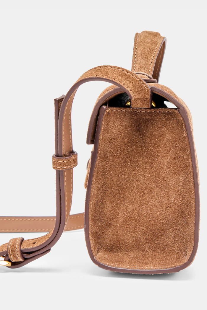 Brown leather crossbody bag on a light gray background