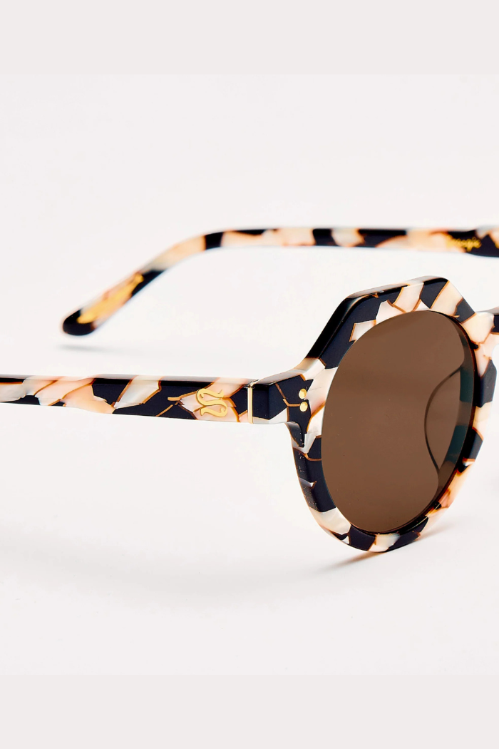 Sunglasses with tortoiseshell frame and brown lens on a white background
