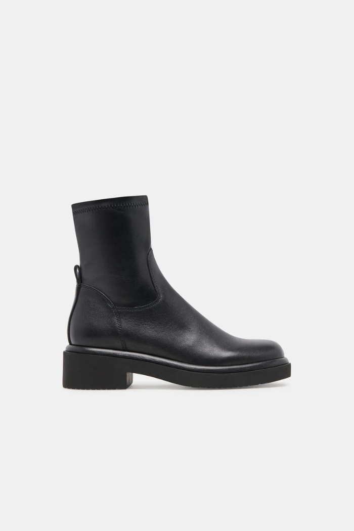 Black Chelsea boot on a light gray background