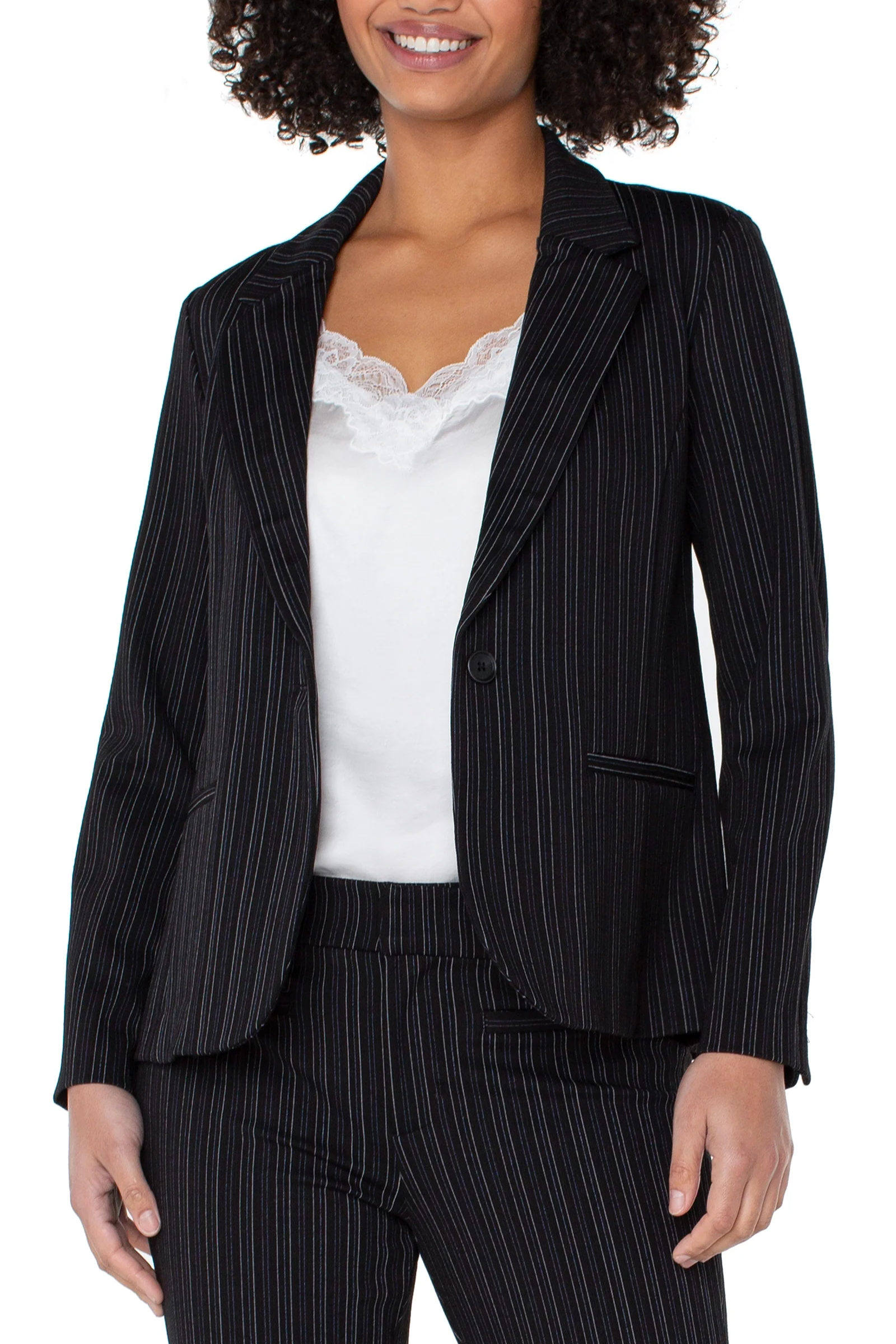 Woman wearing a black pinstripe suit with a white top on a white background