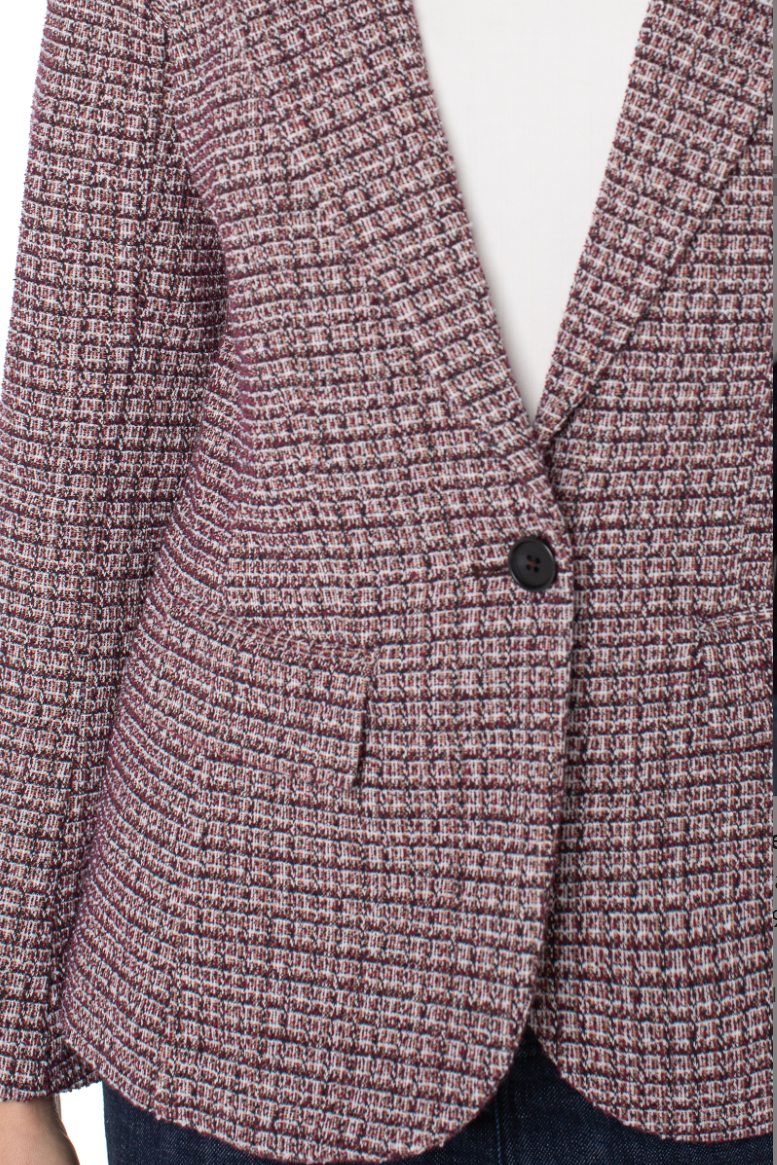 Close-up of a textured blazer with a single button on a white background