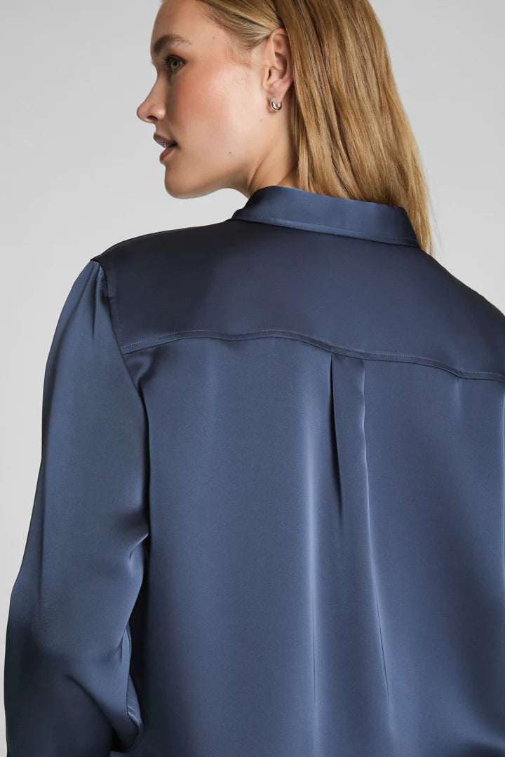 Navy satin shirt worn by a model on a plain background