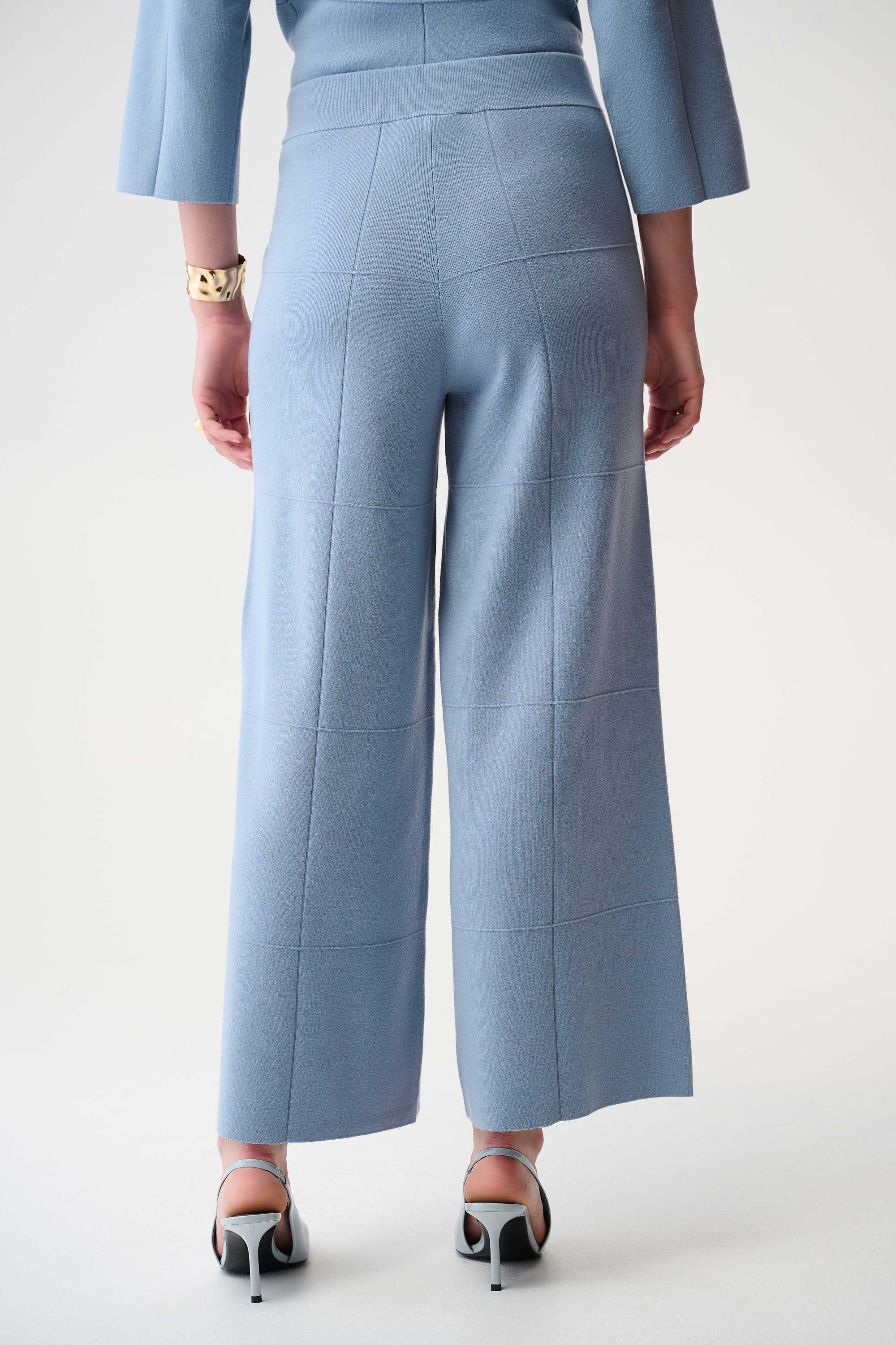 Light blue outfit with wide-leg pants on a plain background
