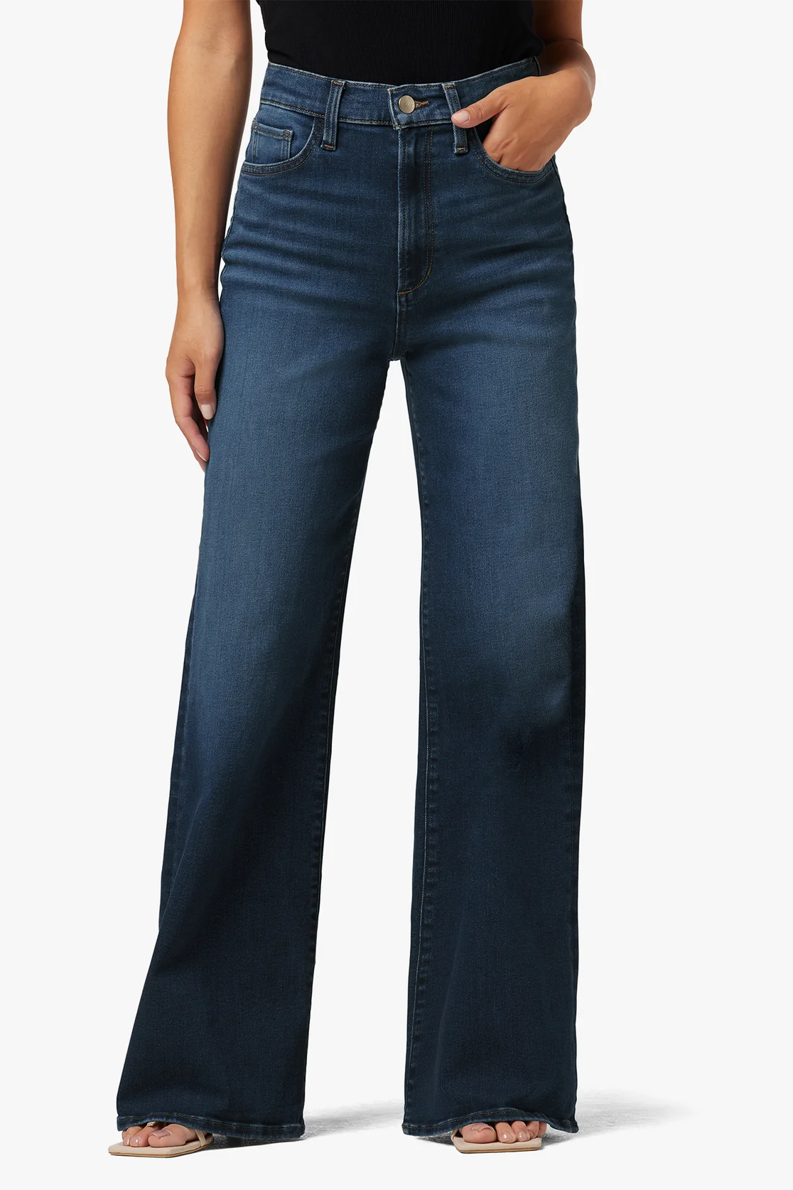 Person wearing blue jeans on a white background