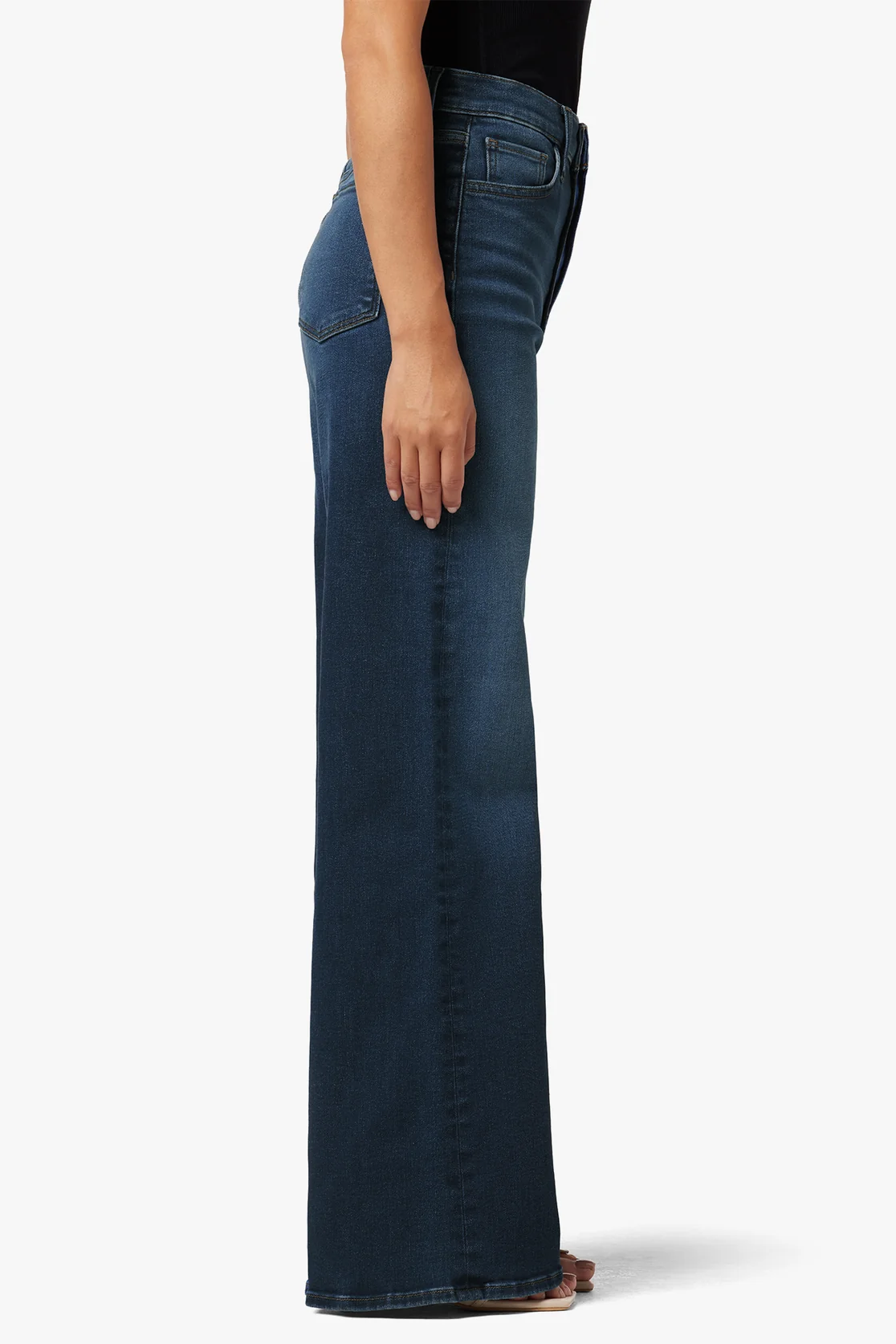 Blue jeans worn by a person on a white background