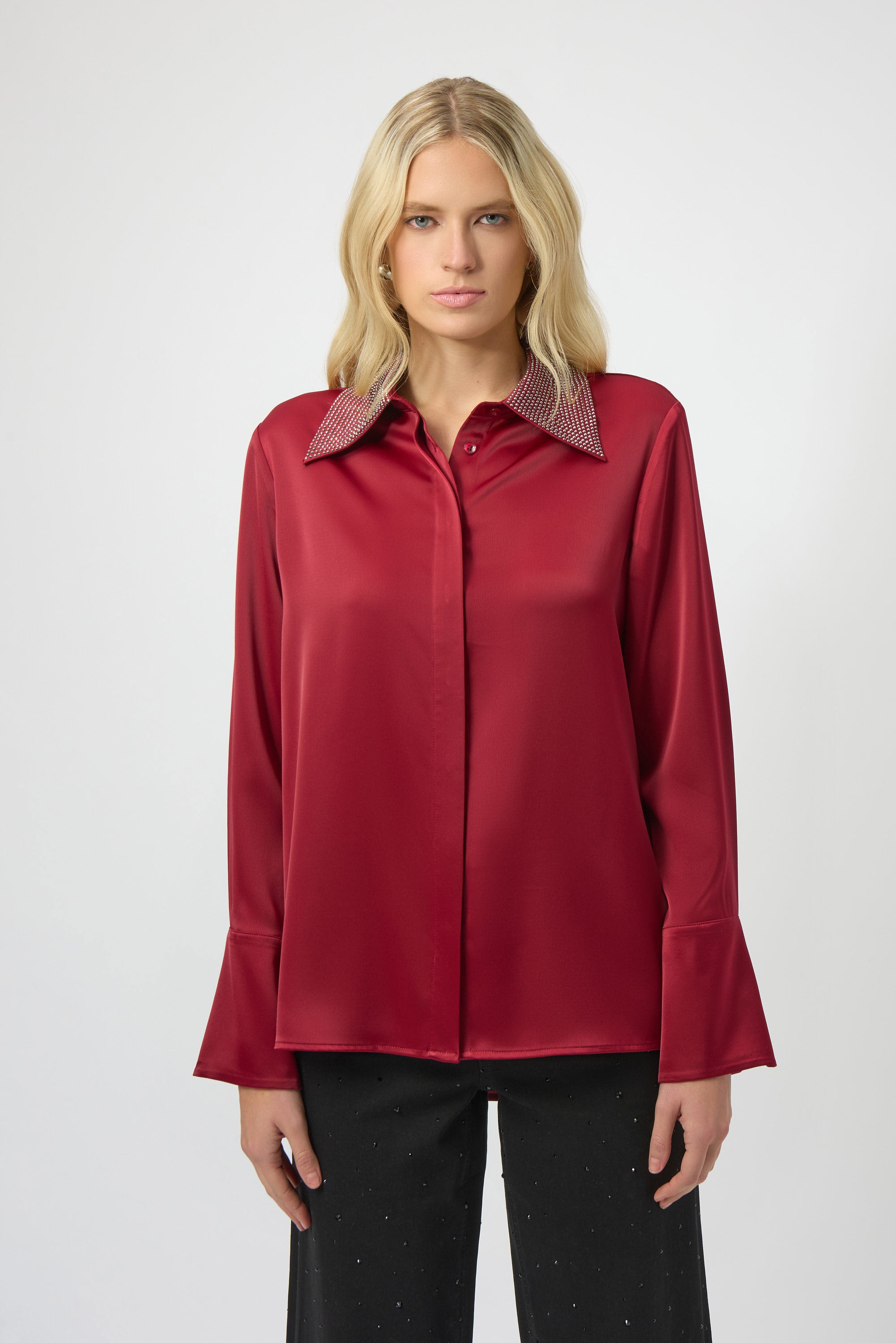 Woman wearing a red blouse with a white background