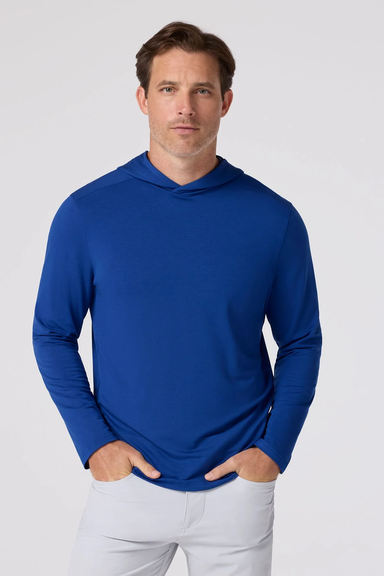 Man wearing a blue long-sleeve shirt against a white background