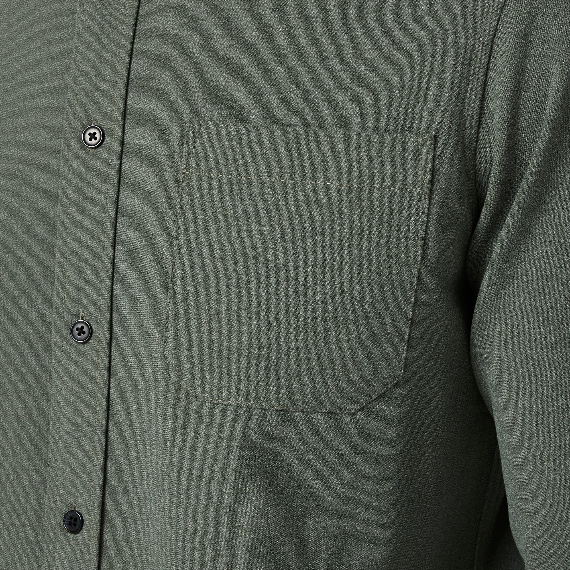 Close-up of a green button-up shirt with a pocket and buttons.