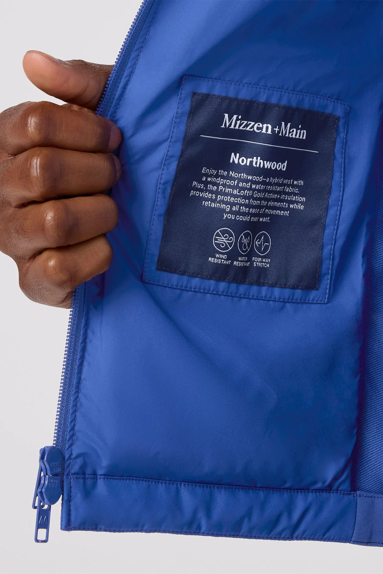Blue jacket with a brand label on a white background