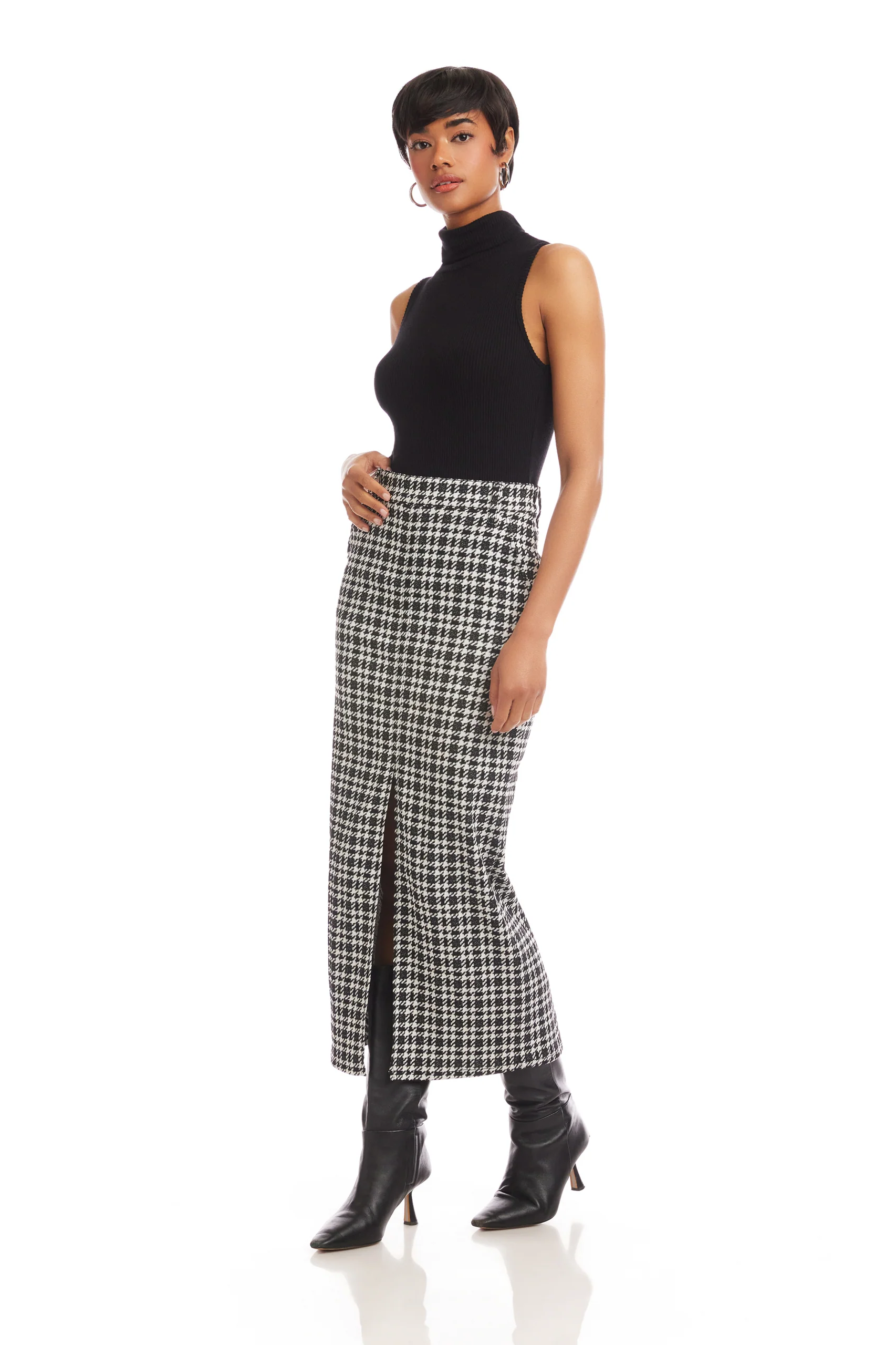 Woman wearing a black turtleneck and plaid skirt on a white background