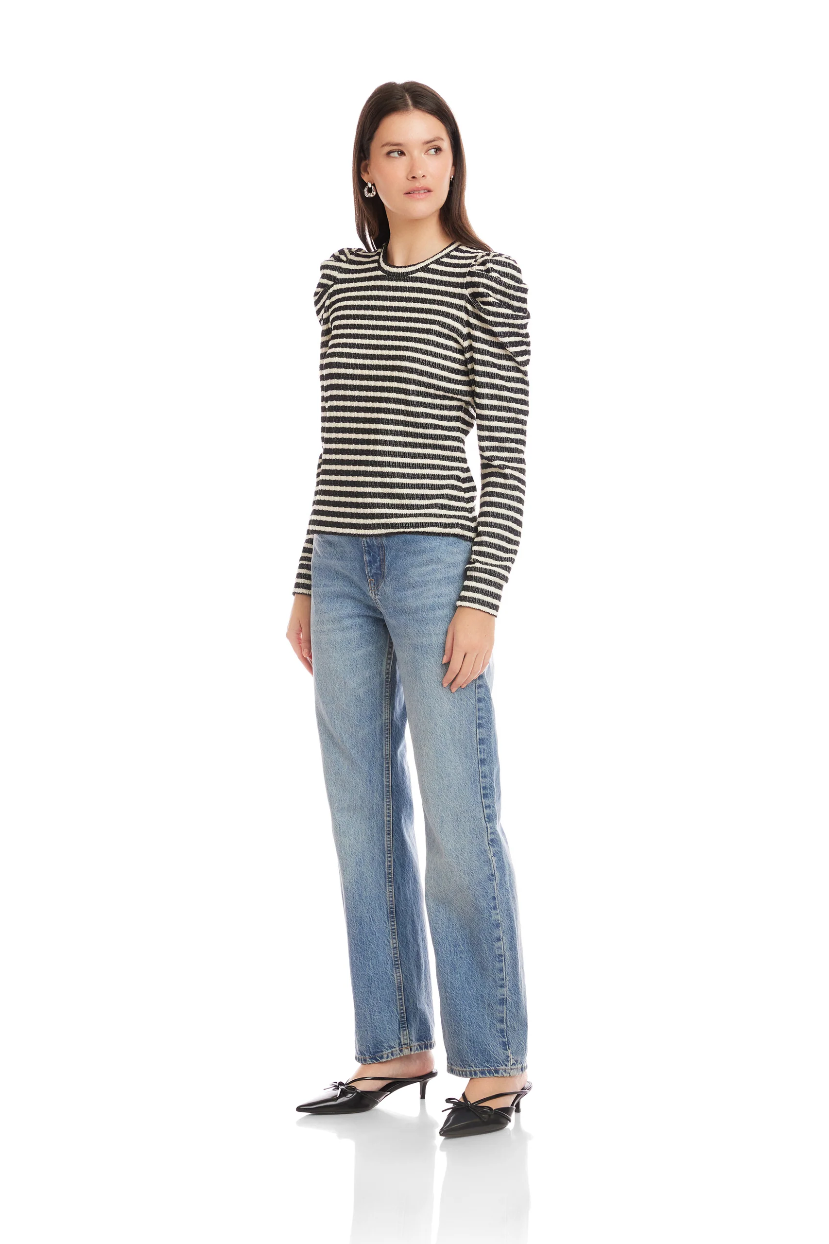 Woman wearing a striped shirt and jeans on a white background