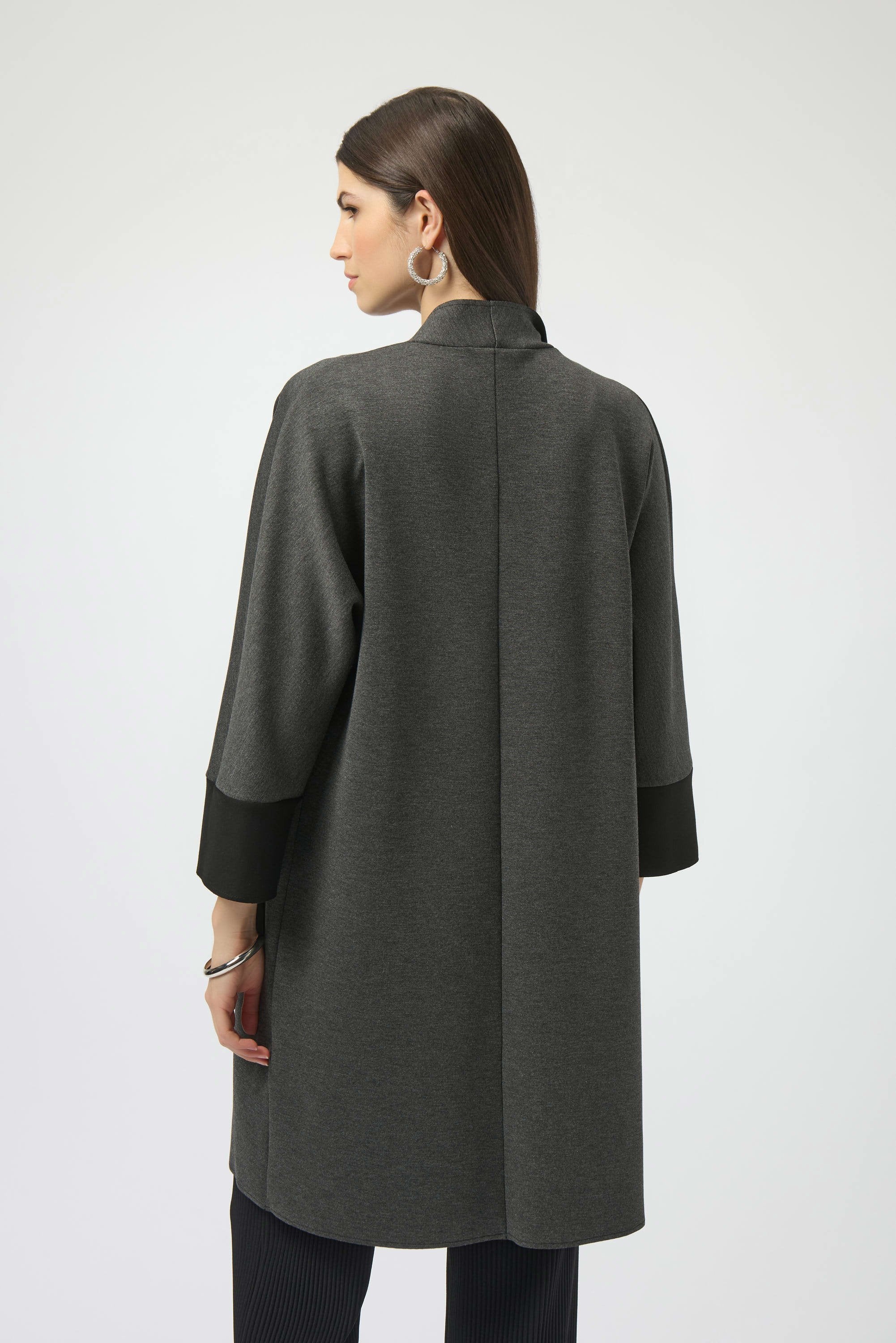 Woman wearing a gray coat on a white background