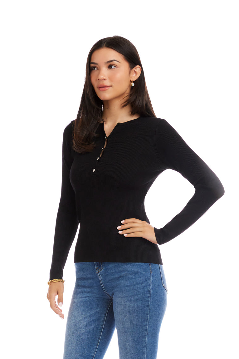 Woman wearing a black long-sleeve top and blue jeans on a white background