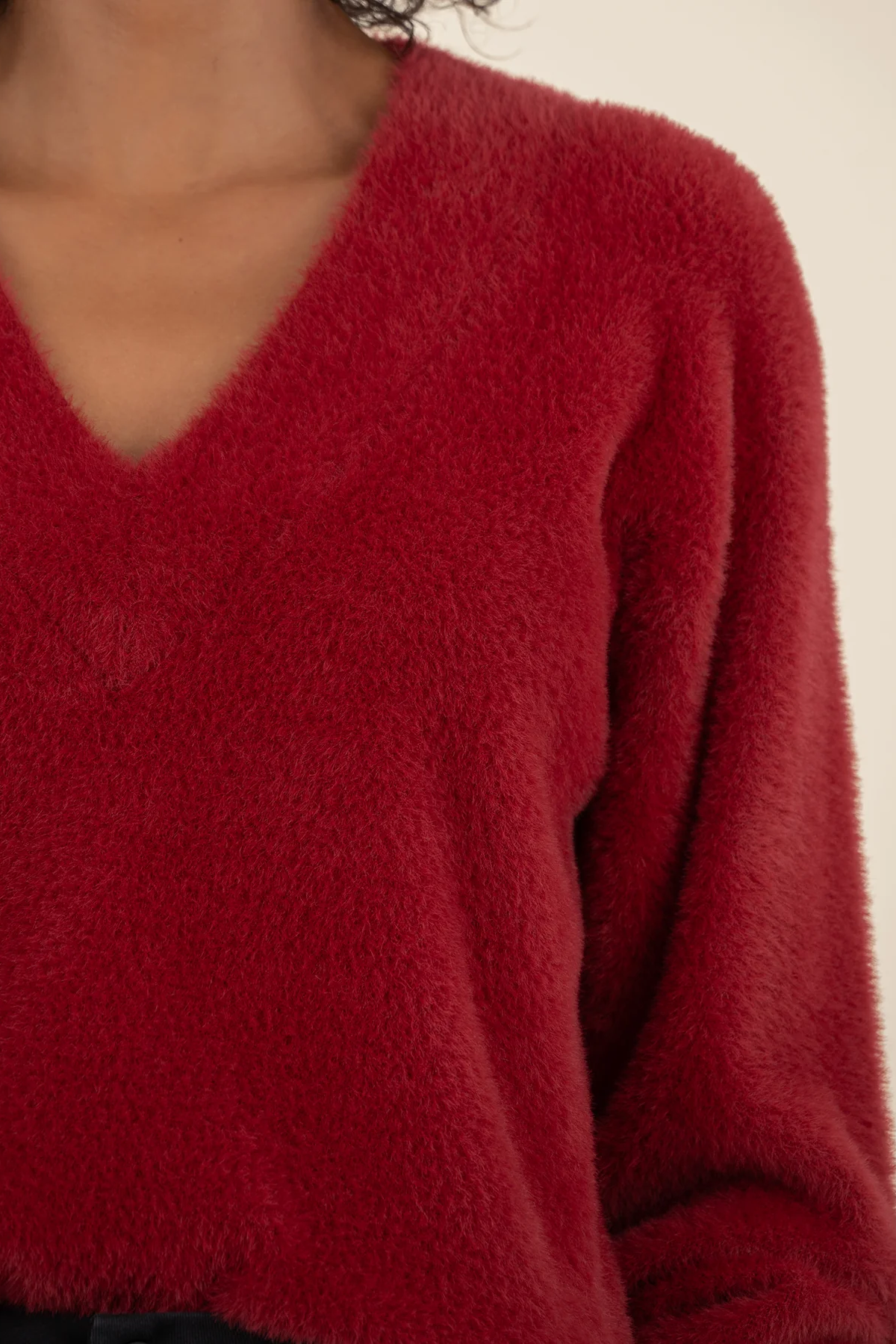 Close-up of a red sweater with a blurred background