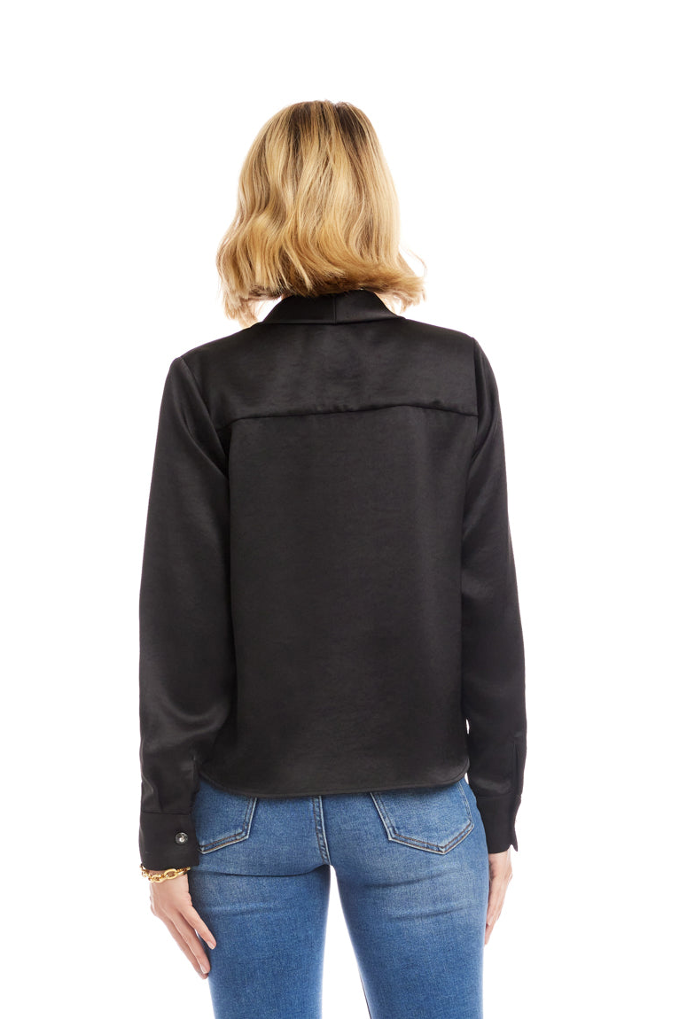 Person wearing a black jacket and blue jeans on a white background
