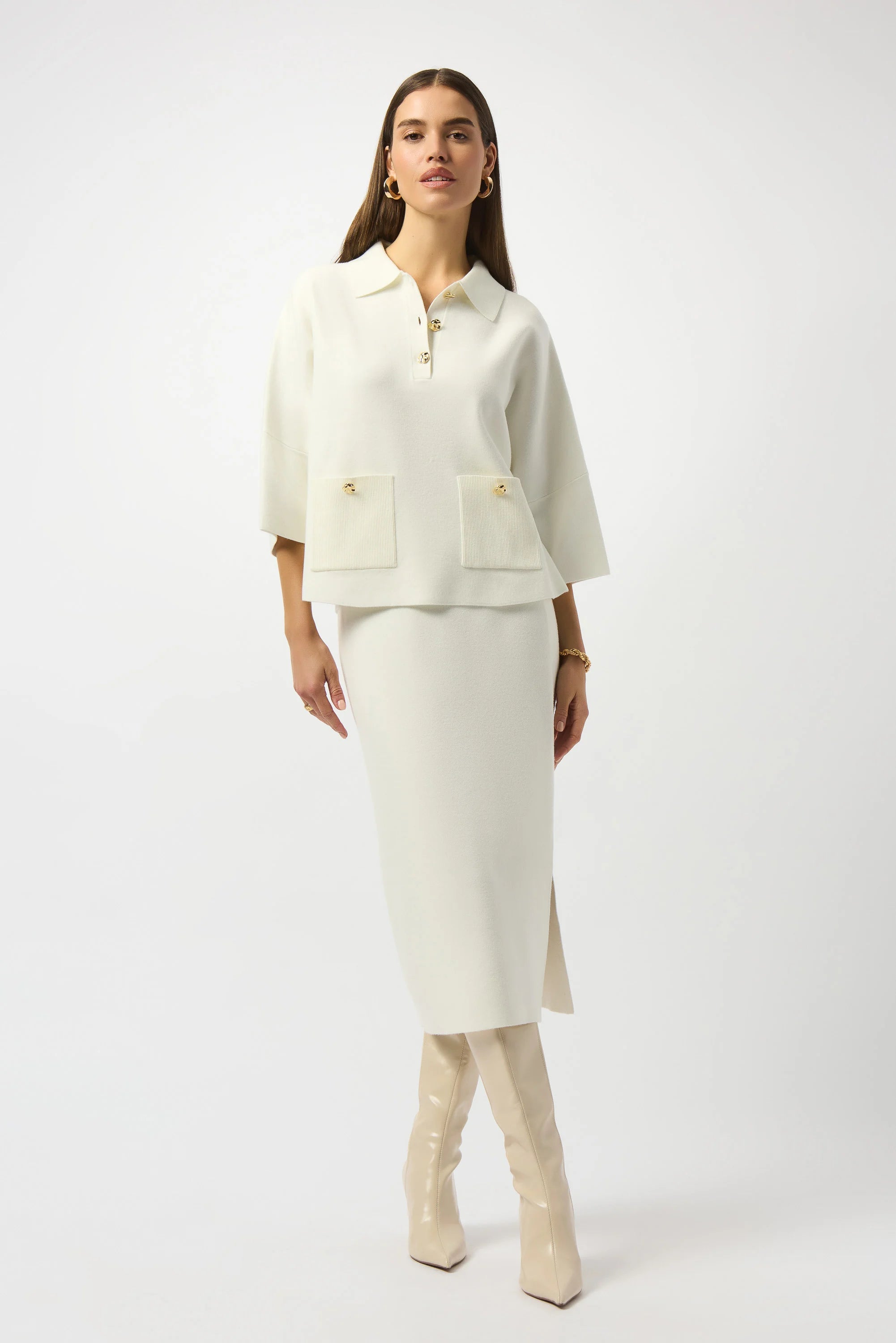 Woman wearing a cream-colored suit with a white background