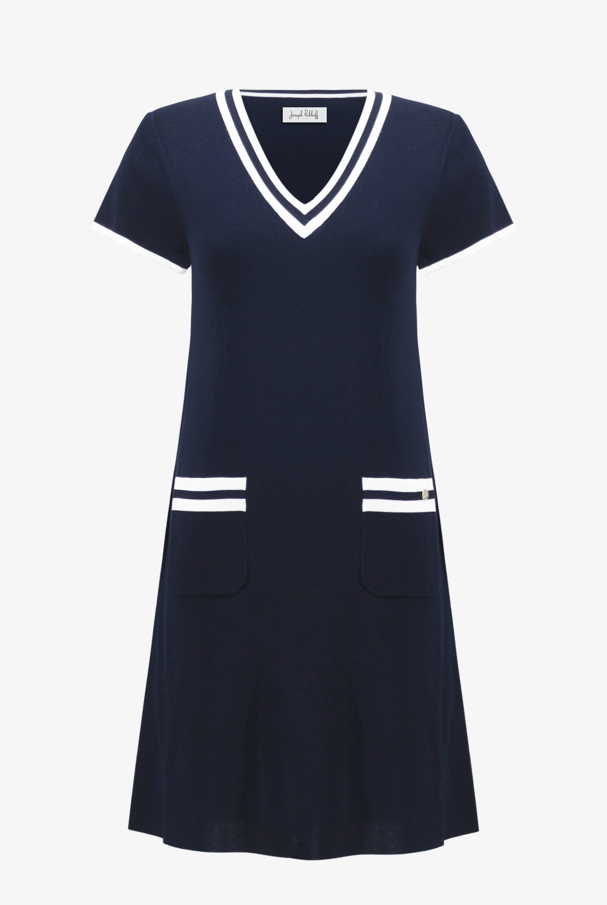 Navy dress with white accents on a white background