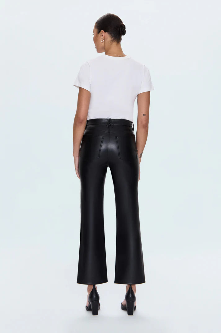 Person wearing a white t-shirt and black leather pants on a light blue background