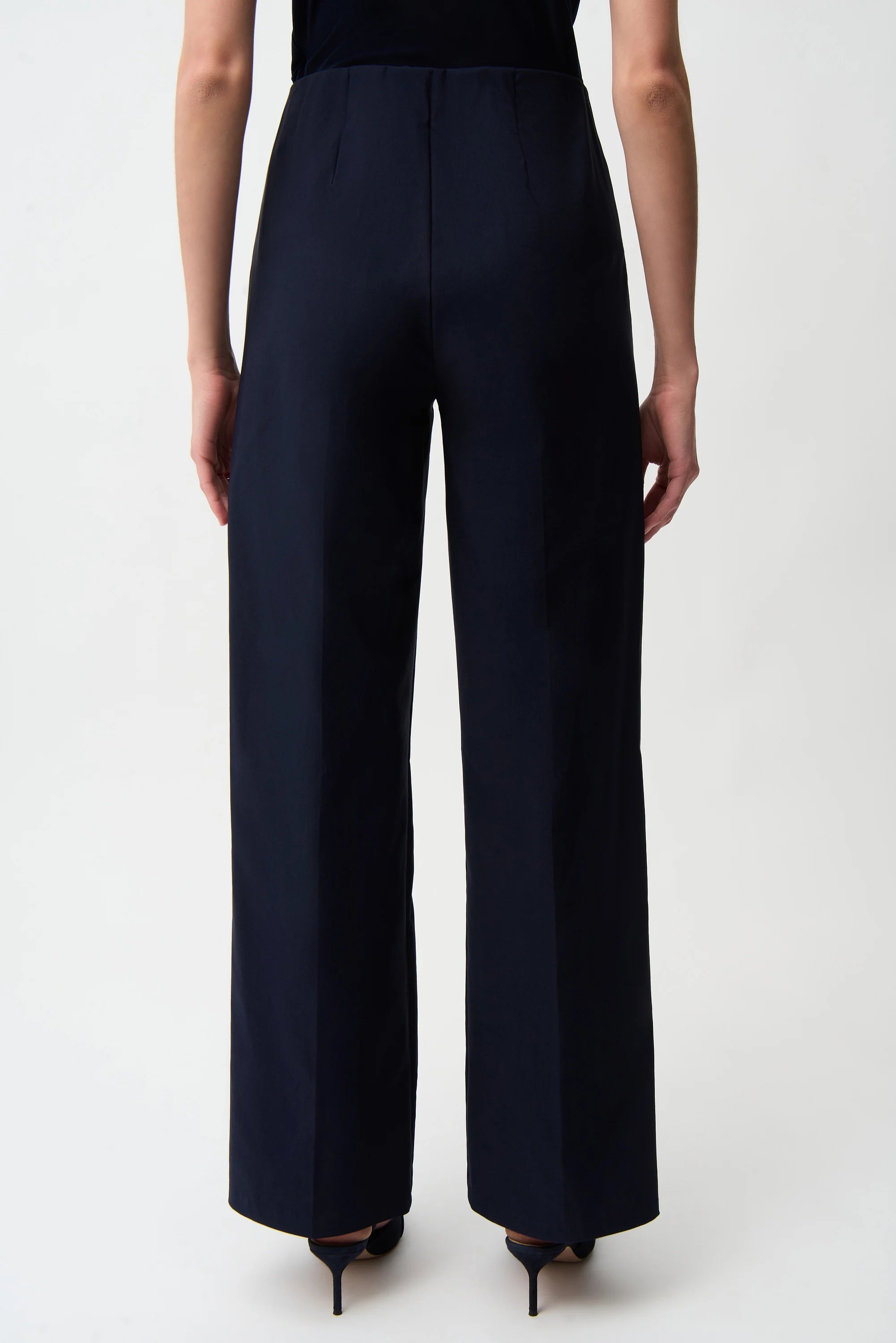 Navy blue wide-leg pants worn by a person on a white background