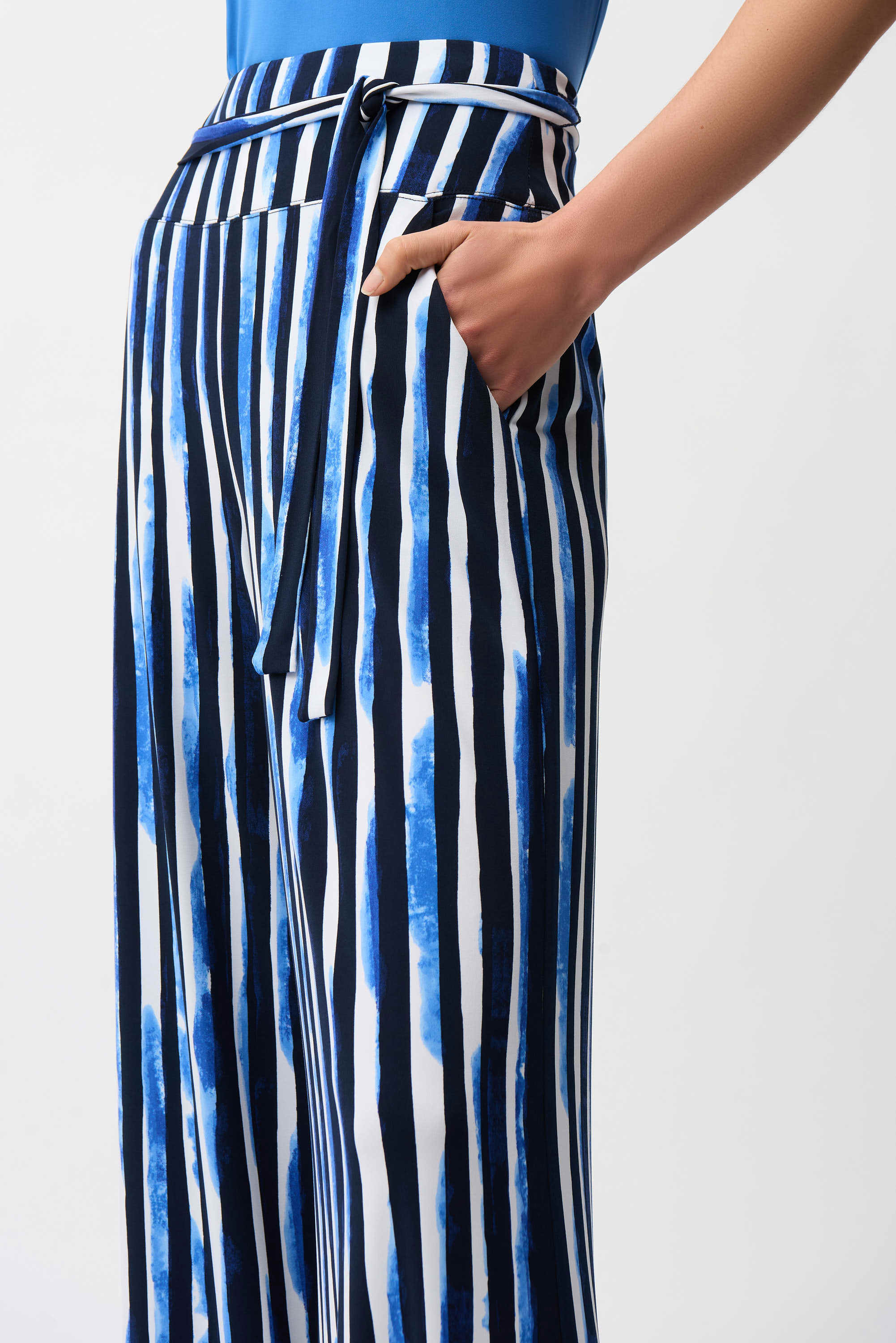 Striped pants with a blue top on a white background