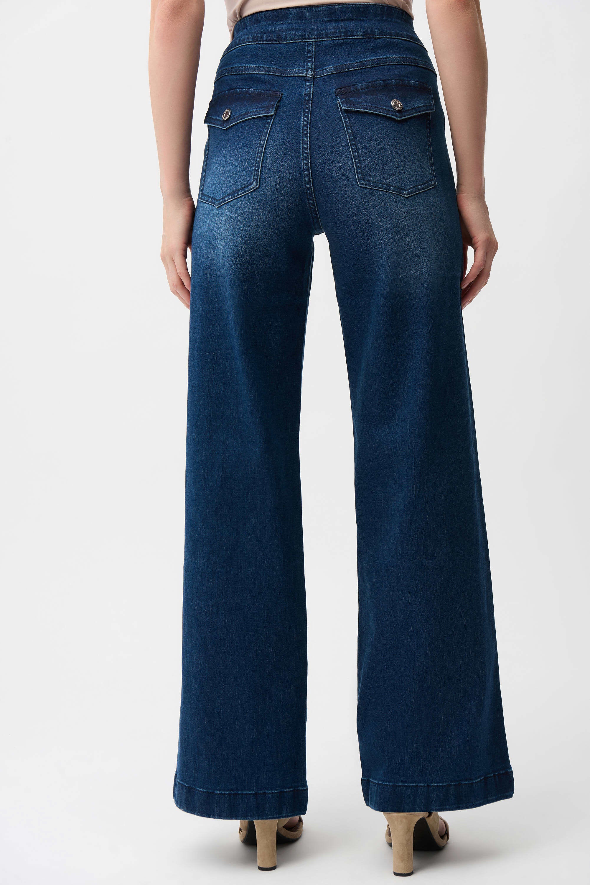 Blue jeans worn by a person on a white background