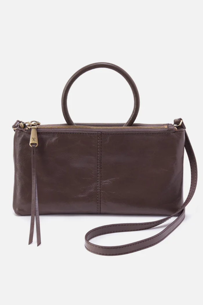 Brown leather handbag with a strap on a white background