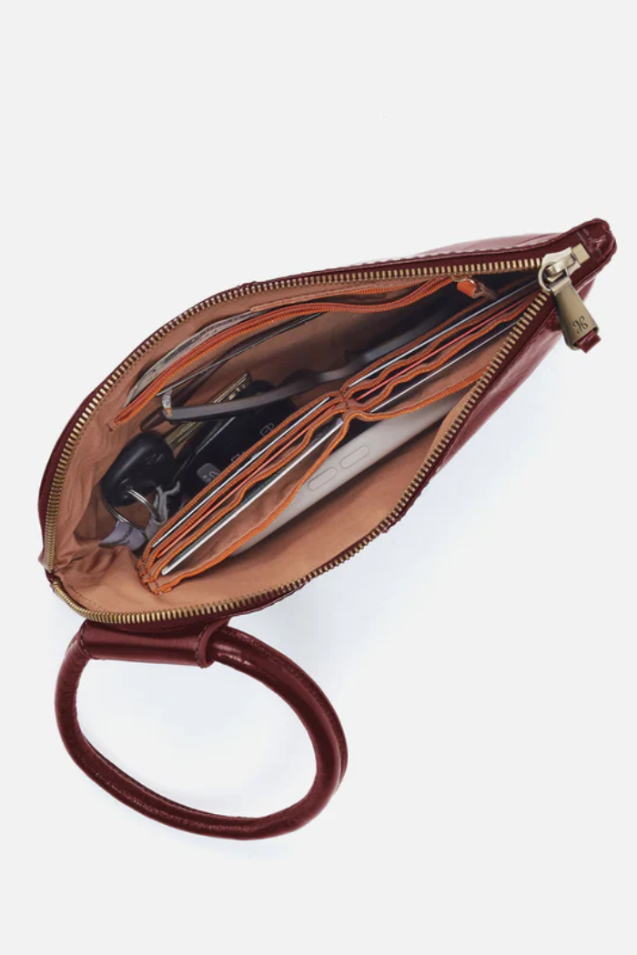 Brown leather clutch with handle on a white background