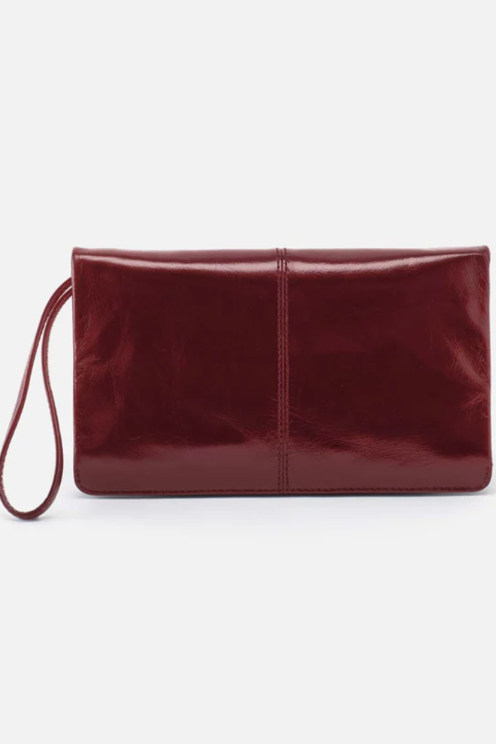 Maroon clutch bag with a strap on a white background