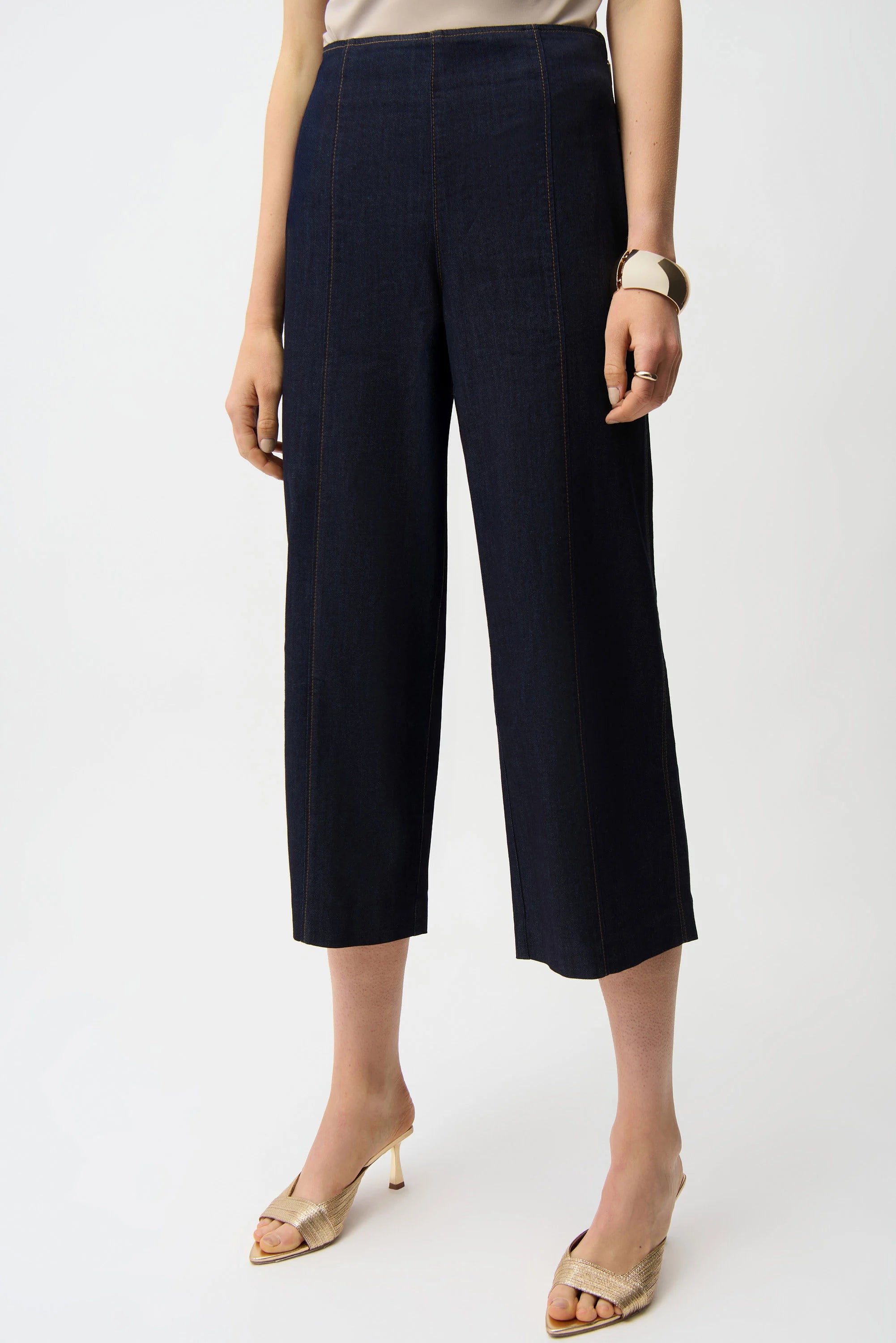 Navy blue wide-leg pants worn by a person on a white background