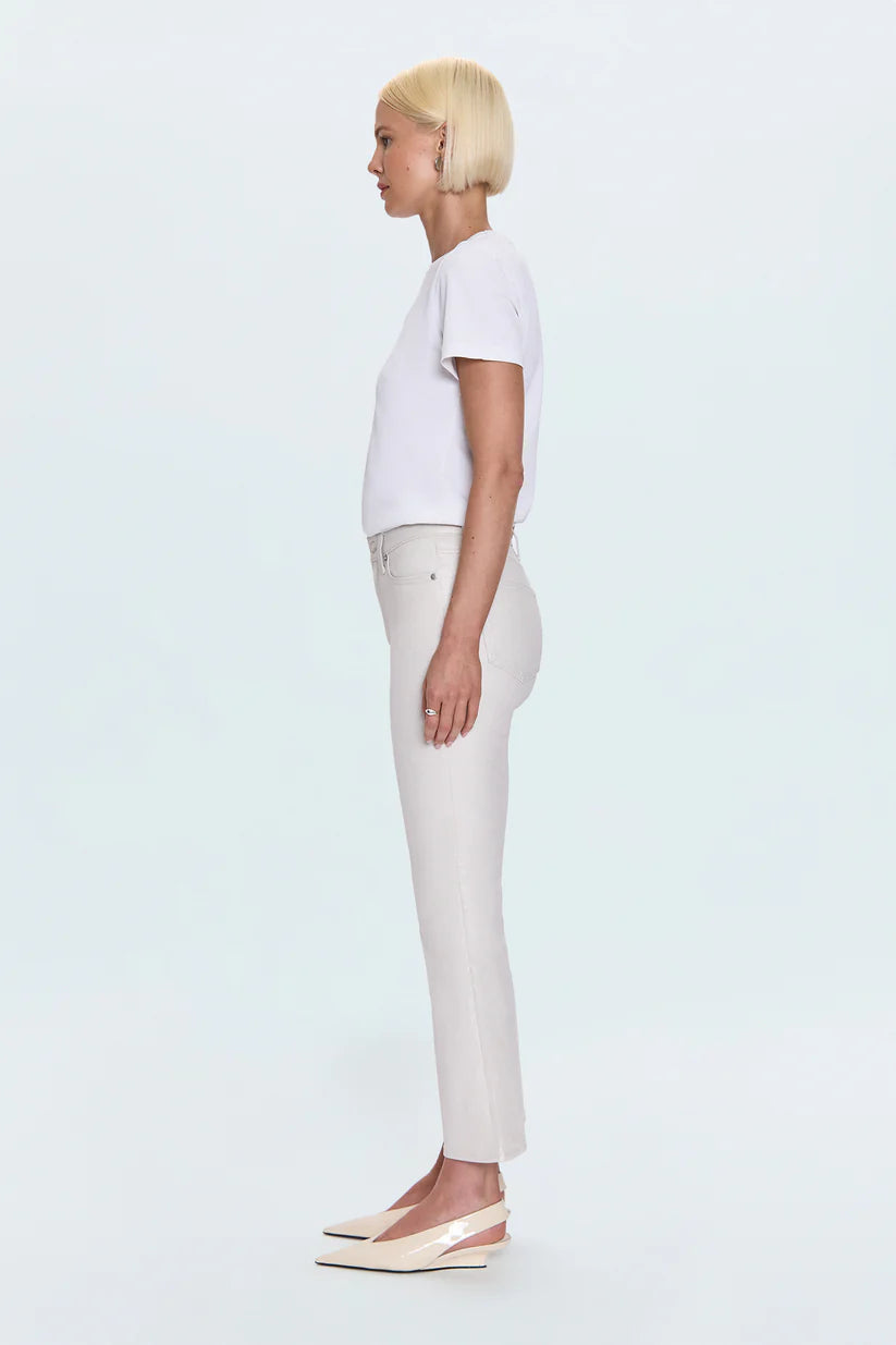 Person wearing a white t-shirt and white pants on a light blue background