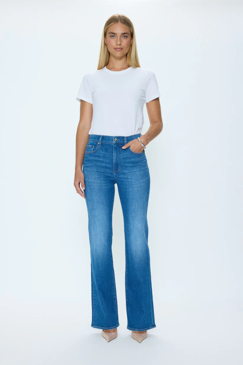Woman wearing a white t-shirt and blue jeans on a white background