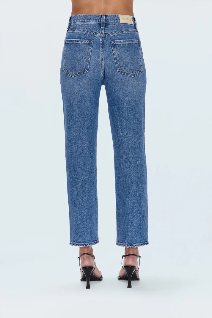 Blue jeans worn by a person on a white background