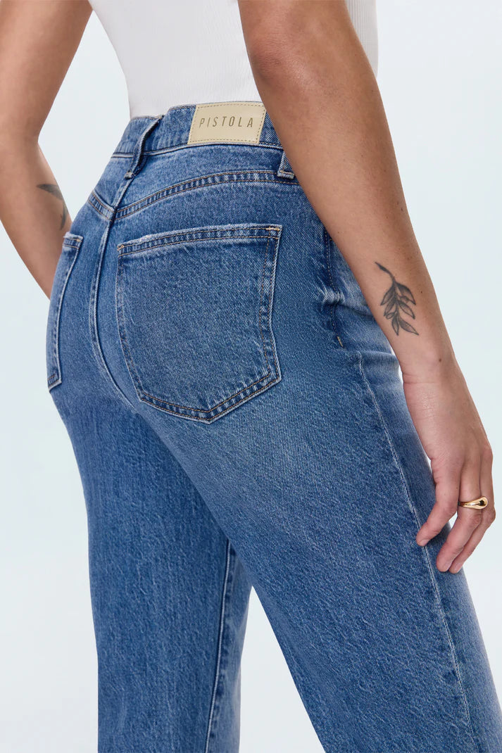 Blue jeans with a visible brand label on a white background