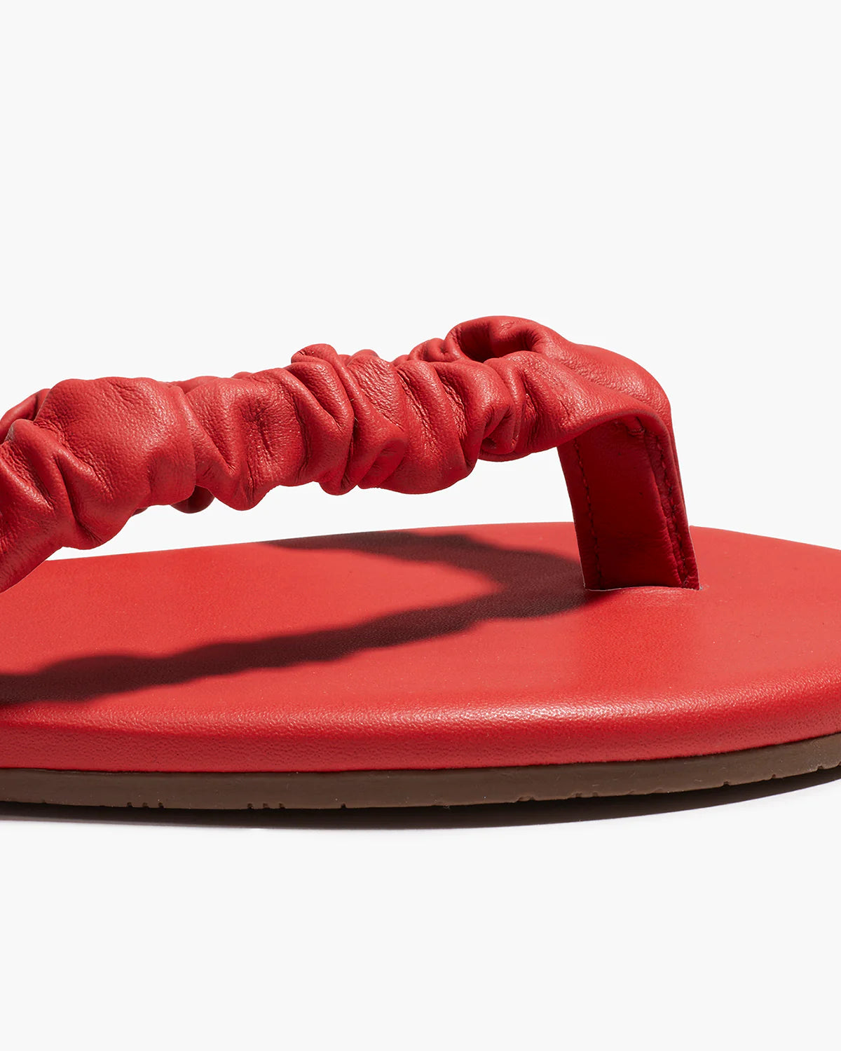 Red sandal with a strap on a white background