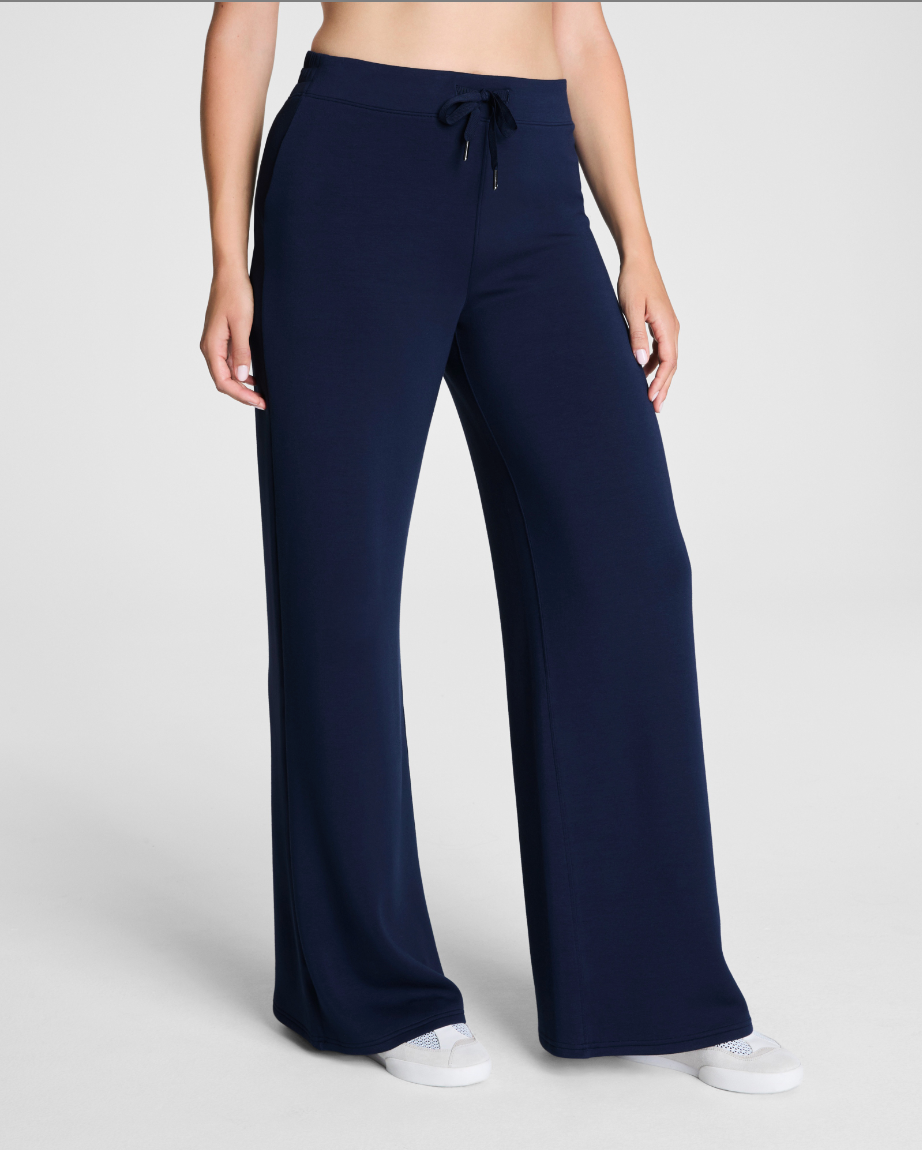 Navy blue wide-leg pants worn by a person on a white background