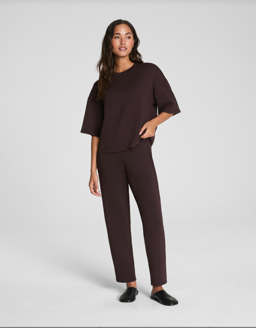 Woman wearing a brown outfit on a white background