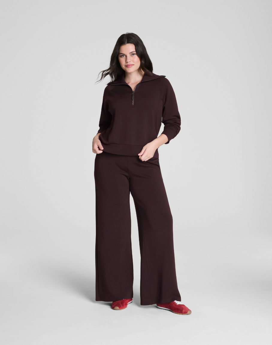 Woman wearing a brown outfit on a white background