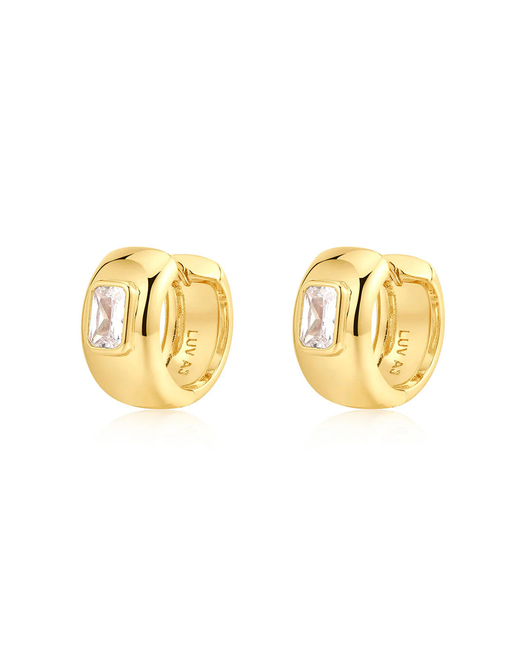 Gold hoop earrings with clear gemstones on a white background