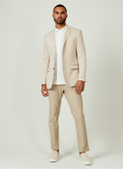 Man wearing a beige suit with a white shirt on a plain background