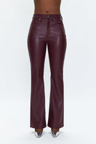 Burgundy leather pants on a white background
