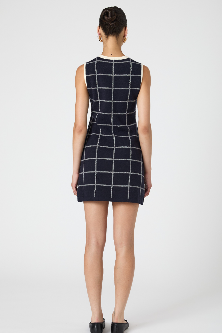 Woman wearing a black and white checkered dress on a white background
