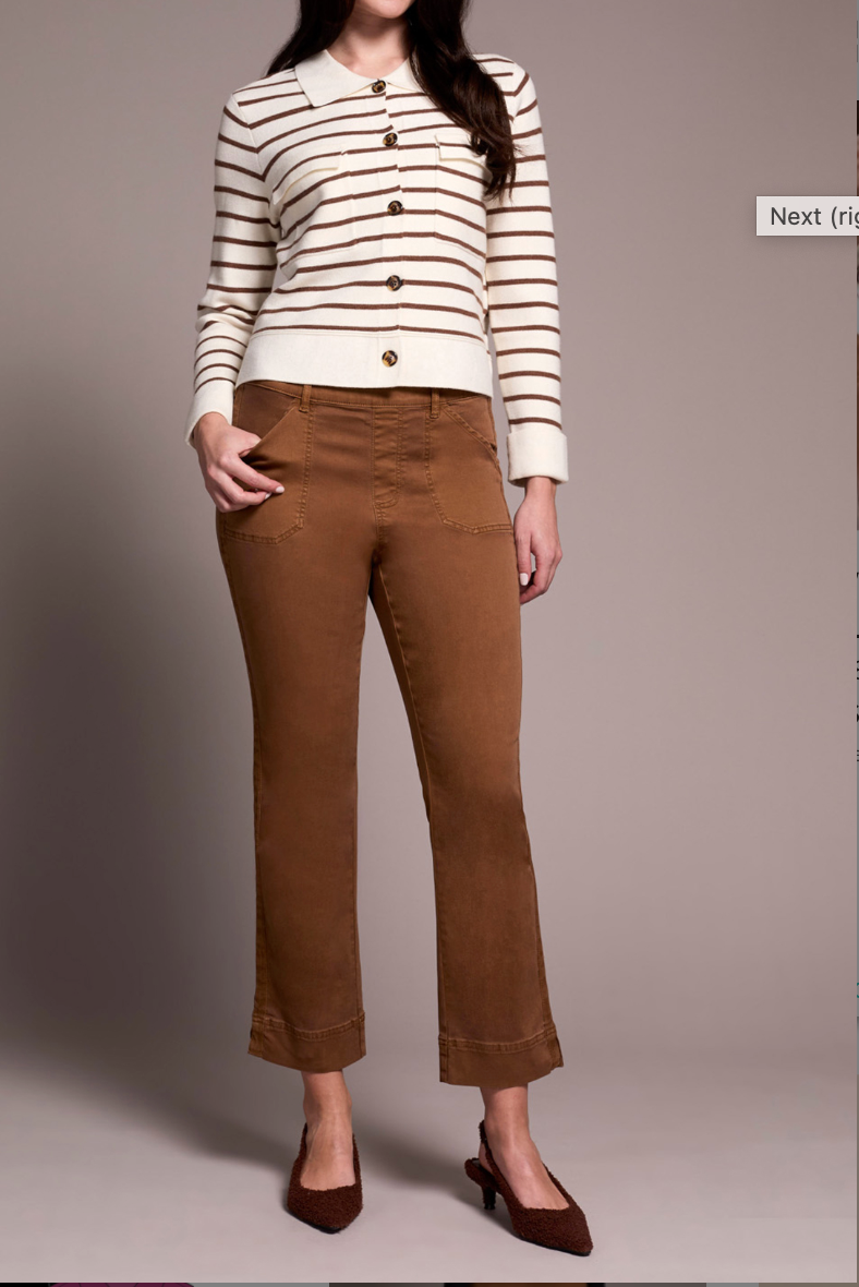 Person wearing a striped sweater and brown pants on a plain background