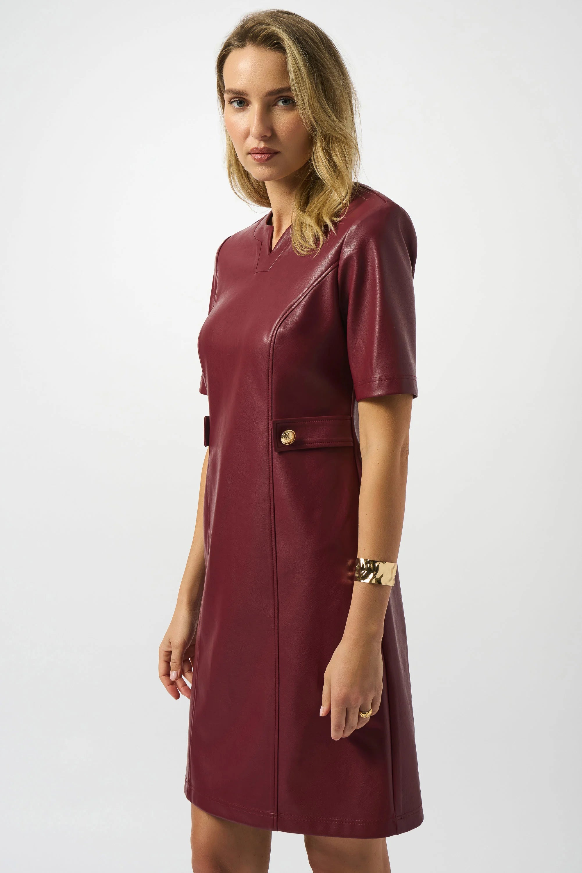 Woman wearing a burgundy dress with a white background