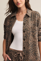 Person wearing a leopard print jacket over a white top
