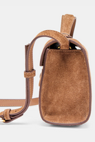 Brown leather crossbody bag on a light gray background